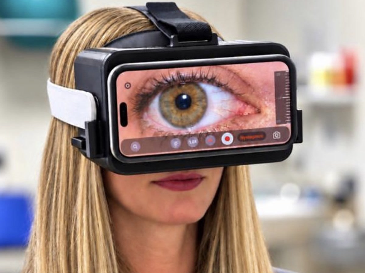 A patient wearing the SmartVertigo headset with an iPhone in it, the eye on its screen